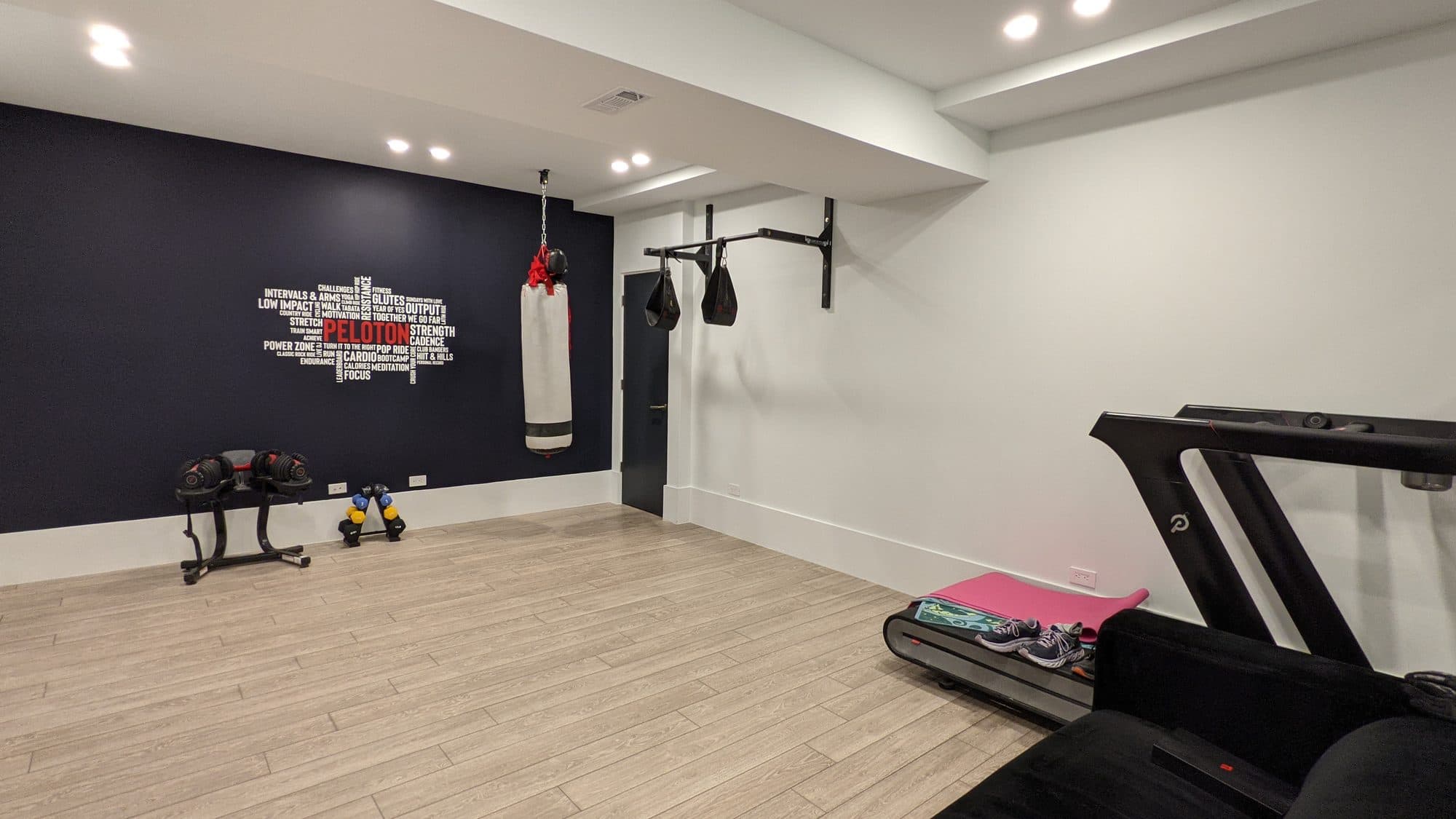 Finished basement home gym with wood flooring