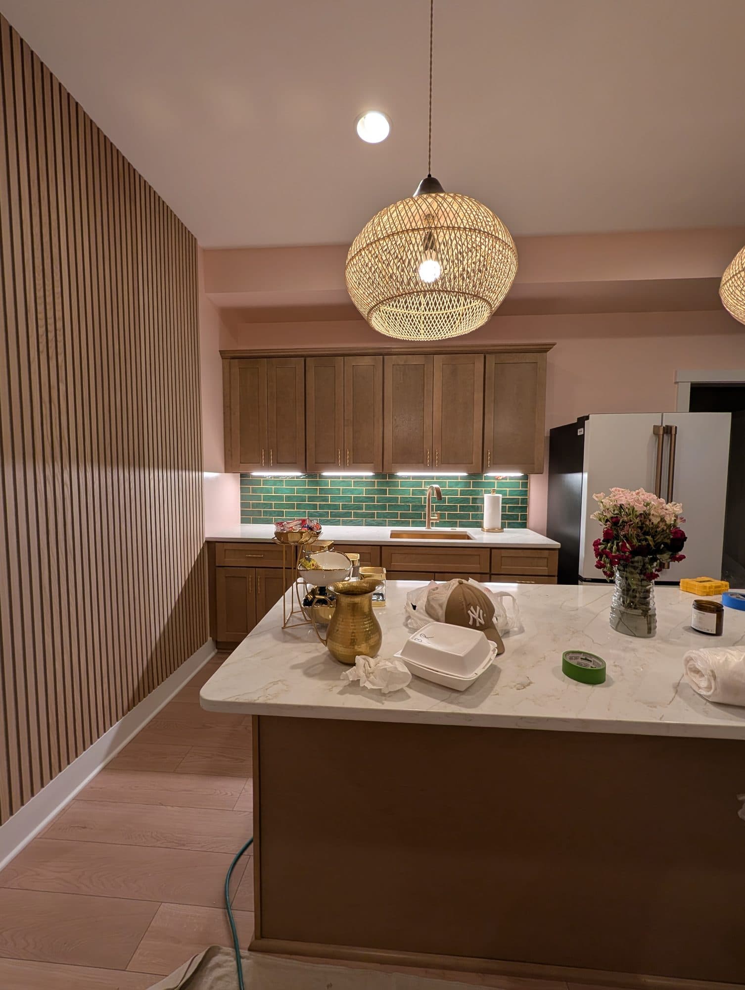 Finished basement wet bar with tile backsplash, wood cabinetry, and marble countertop