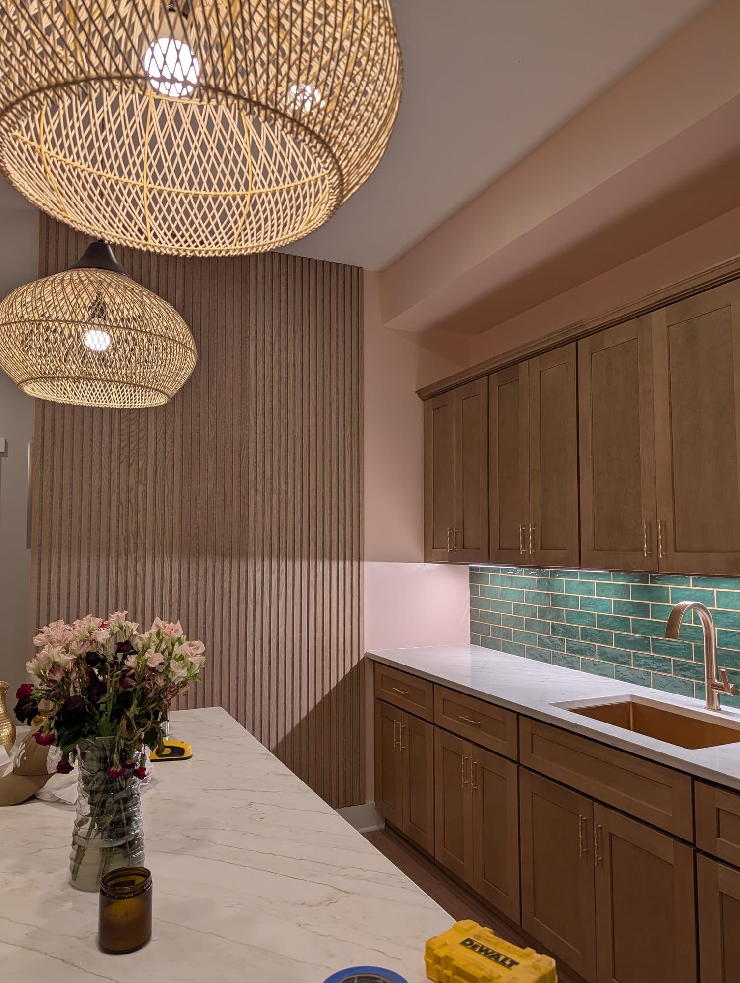 Finished basement wet bar close-up with woven pendant lighting