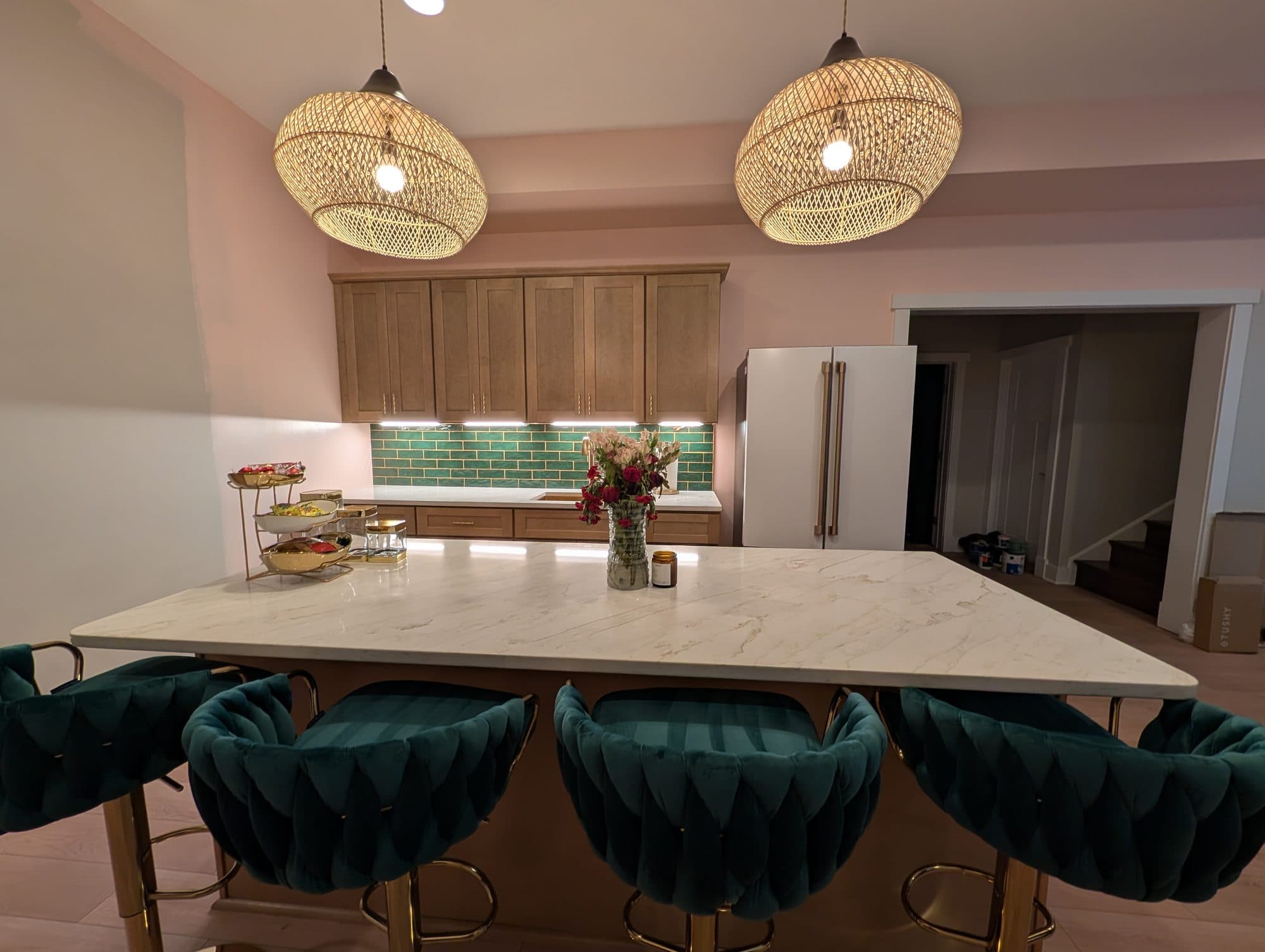 Finished basement wet bar fully furnished with teal velvet bar stools